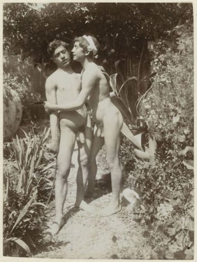 Two naked boys on a garden path