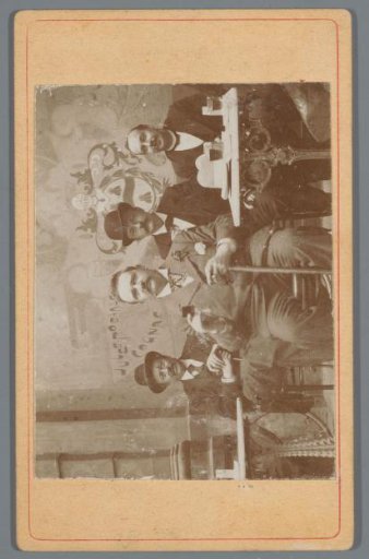 Group portrait with four men on a café terrace