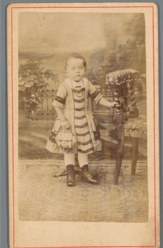 Portrait of an unknown girl next to a chair