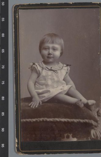 Portrait of an unknown child on a cushion