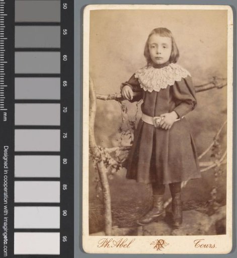 Portrait of an unknown child by a fence