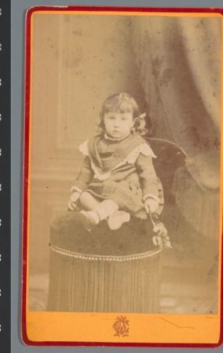 Portrait of an unknown child on a chair