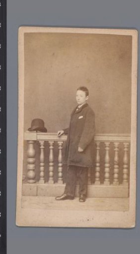 Portrait of an unknown boy with round hat before a balustrade