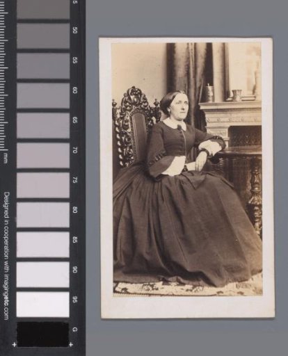 Portrait of an unknown woman at a table