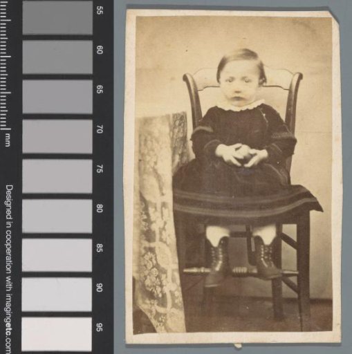 Portrait of an unknown child on a chair