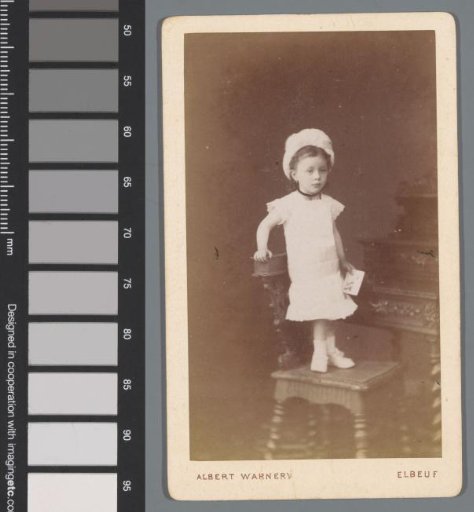 Portrait of an unknown girl seated on a chair