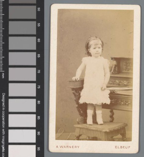 Portrait of an unknown girl seated on a chair