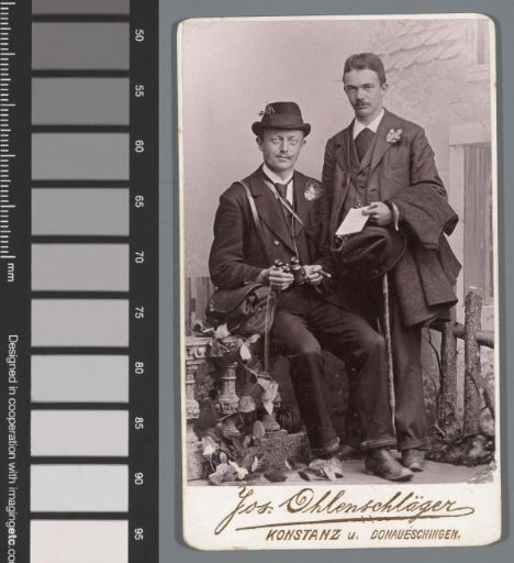 Portrait of two unknown men, one with a spyglass