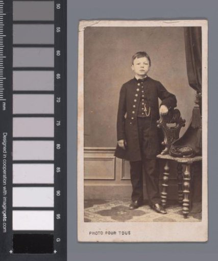 Portrait of an unknown boy by a chair