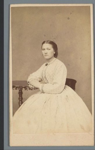 Portrait of an unknown woman at a table