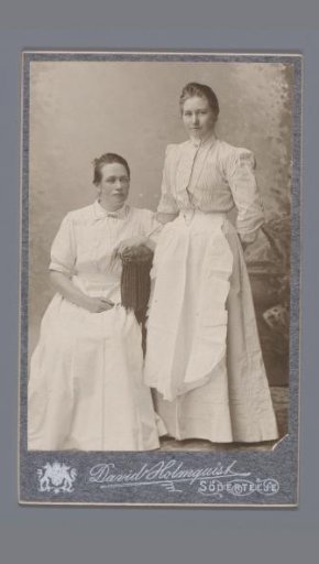 Portrait of two unknown women with aprons