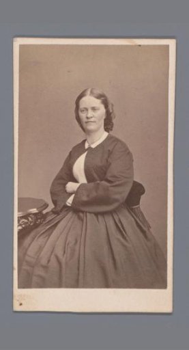 Portrait of an unknown seated woman with her arms crossed