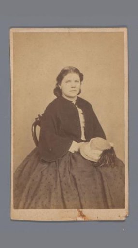 Portrait of an unknown seated woman with a hat on her lap