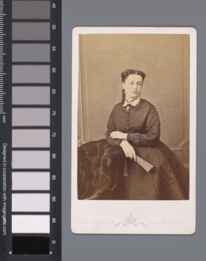 Portrait of an unknown woman leaning on an armchair