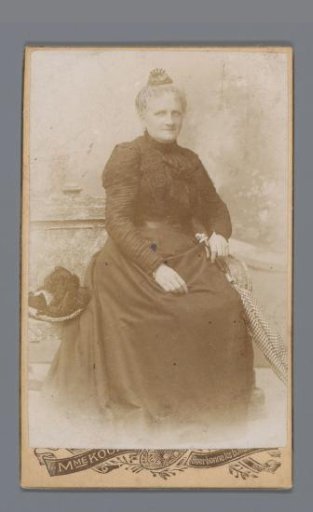 Portrait of an unknown seated woman with a closed parasol in her hand