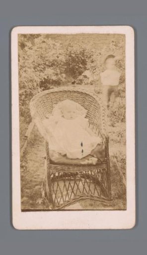 Portrait of an Unknown Baby in a Wicker Chair in a Garden