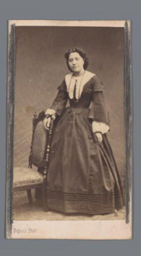 Portrait of an unknown woman by a chair