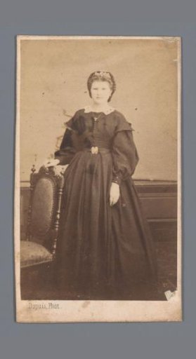 Portrait of an unknown woman by a chair