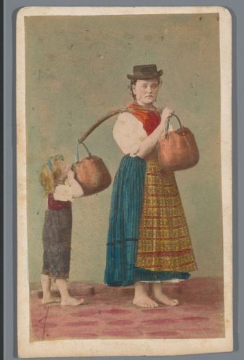 Portrait of an unknown woman in local dress with copper water buckets, a child looking into one of the buckets