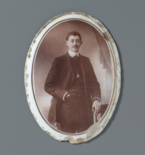 Portrait of an unknown man on a ceramic oval plaque from a grave