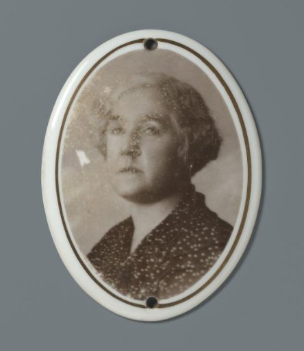 Portrait of an unknown woman on a porcelain oval plaque from a grave