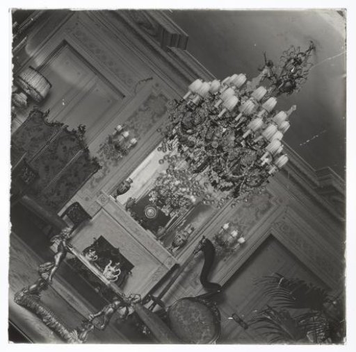 Interior of a room with room screen, harp and chandelier, photograph rotated 45 degrees