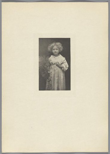 Portrait of an unknown child with a peacock feather