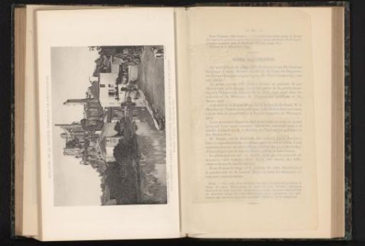 View of a village on a river with a castle ruin, probably in France