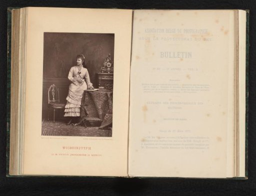Portrait of an unknown standing woman at a table