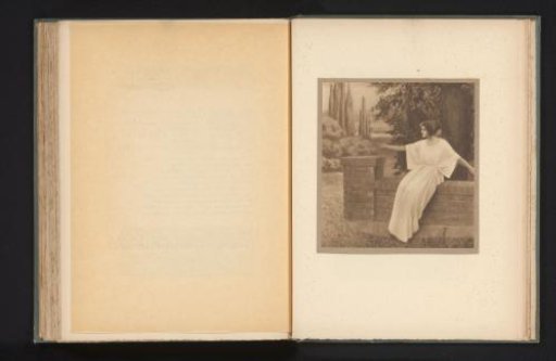 Woman seated on a wall with outstretched arms