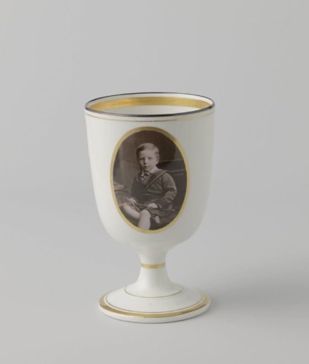 Cup on a foot with a photograph of a boy