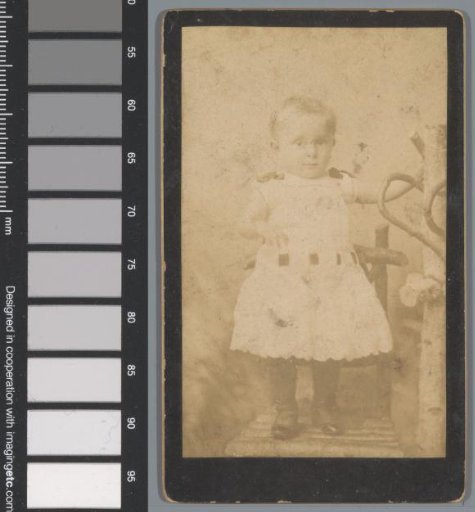 Portrait of an unknown girl standing on a chair