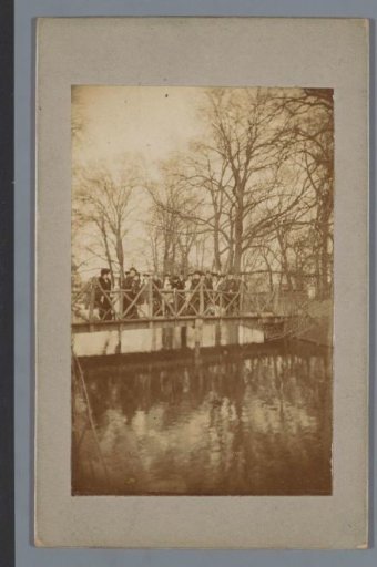 Group of people on a wooden bridge in a park