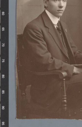 Portrait of an unknown man, sitting with a paper in his hand