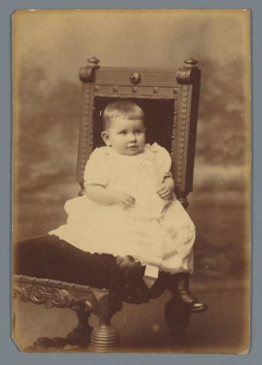 Portrait of an unknown child on a chair