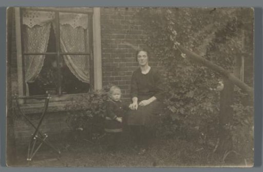Mother with Child in a Garden by a House