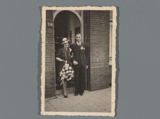 Portrait of an unknown married couple, standing in a doorway