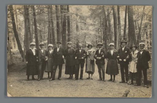 Group portrait of unknown people in a forest