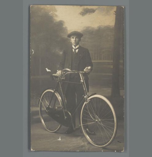 Portrait of an unknown young man with a bicycle