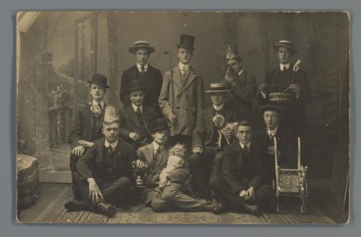 Group portrait of a group of unknown boys with hats and toys