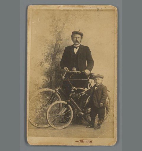 Portrait of an unknown tall and short man with bicycles