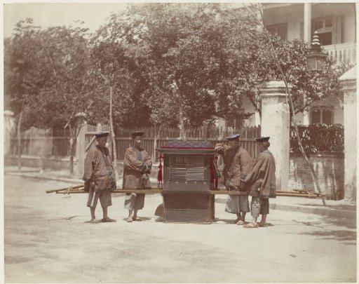 Four men with a sedan chair on the street in China