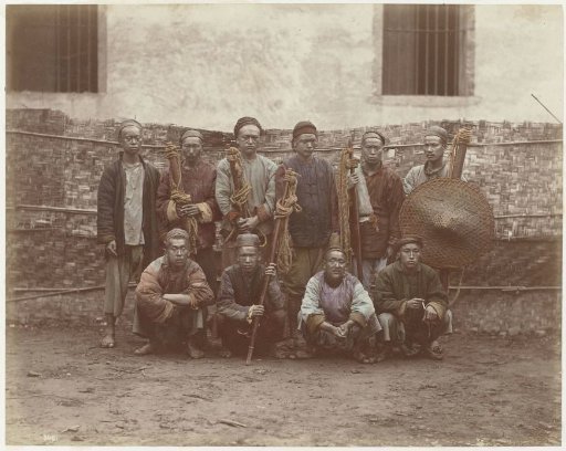 Group portrait with ten men, presumably Chinese bearers