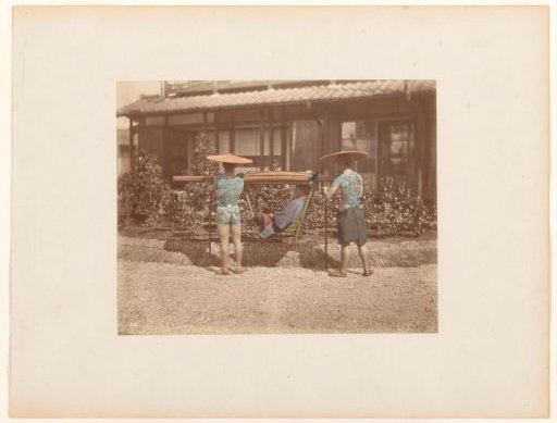 Two tattooed bearers with a man in a kago
