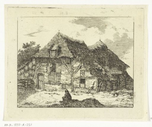 Man sitting on a small hill in front of a house in Staphorst