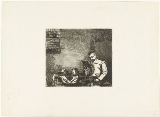 Soldier seated at a table with armour and reading a book