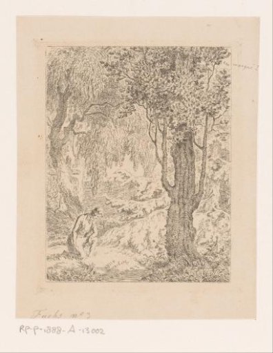 Man kneeling in a wood by a memorial site