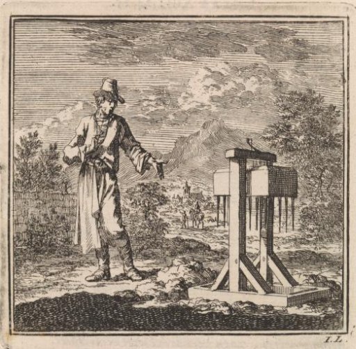 Man pointing at a mole trap
