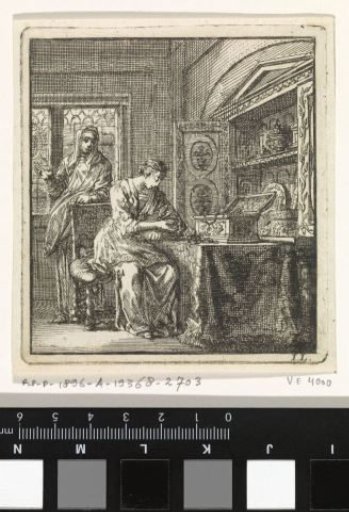 Woman examining the contents of a small chest of valuables