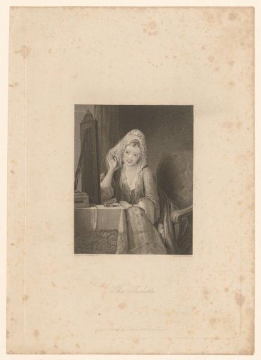 Young woman at a table looks at herself in a mirror